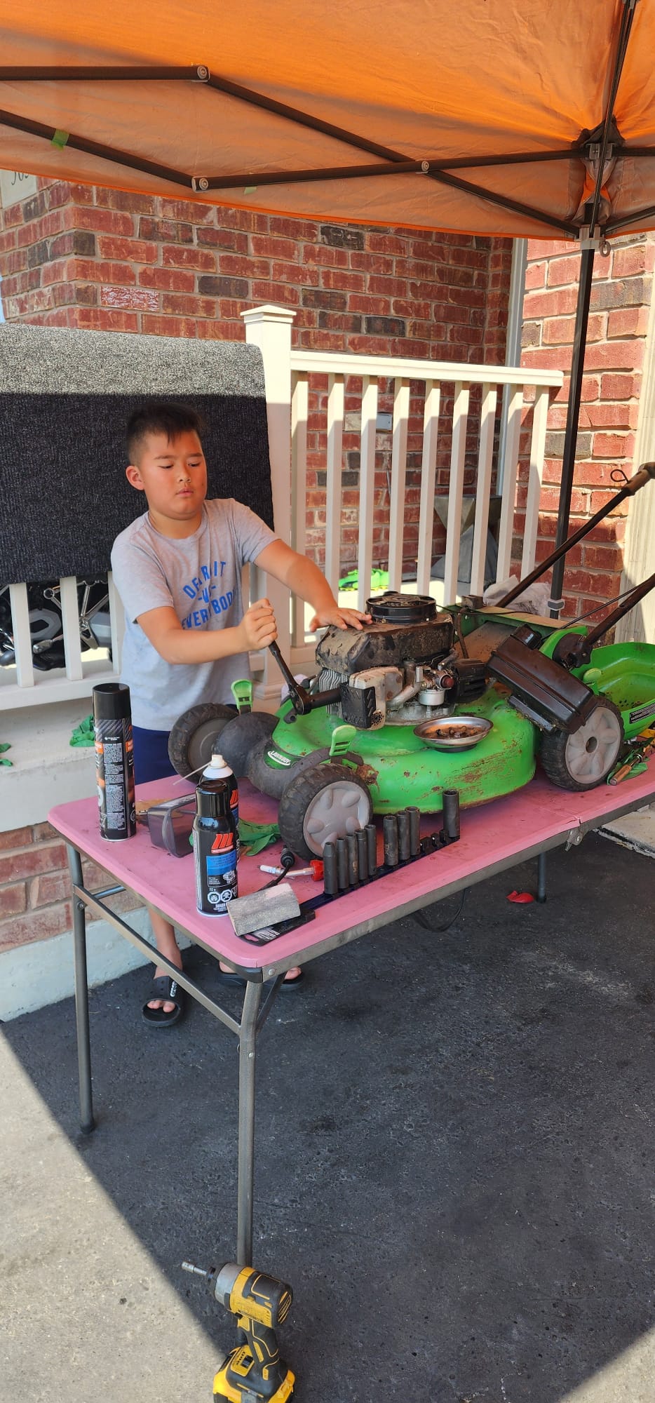 Josh repairing a lawn mower engine